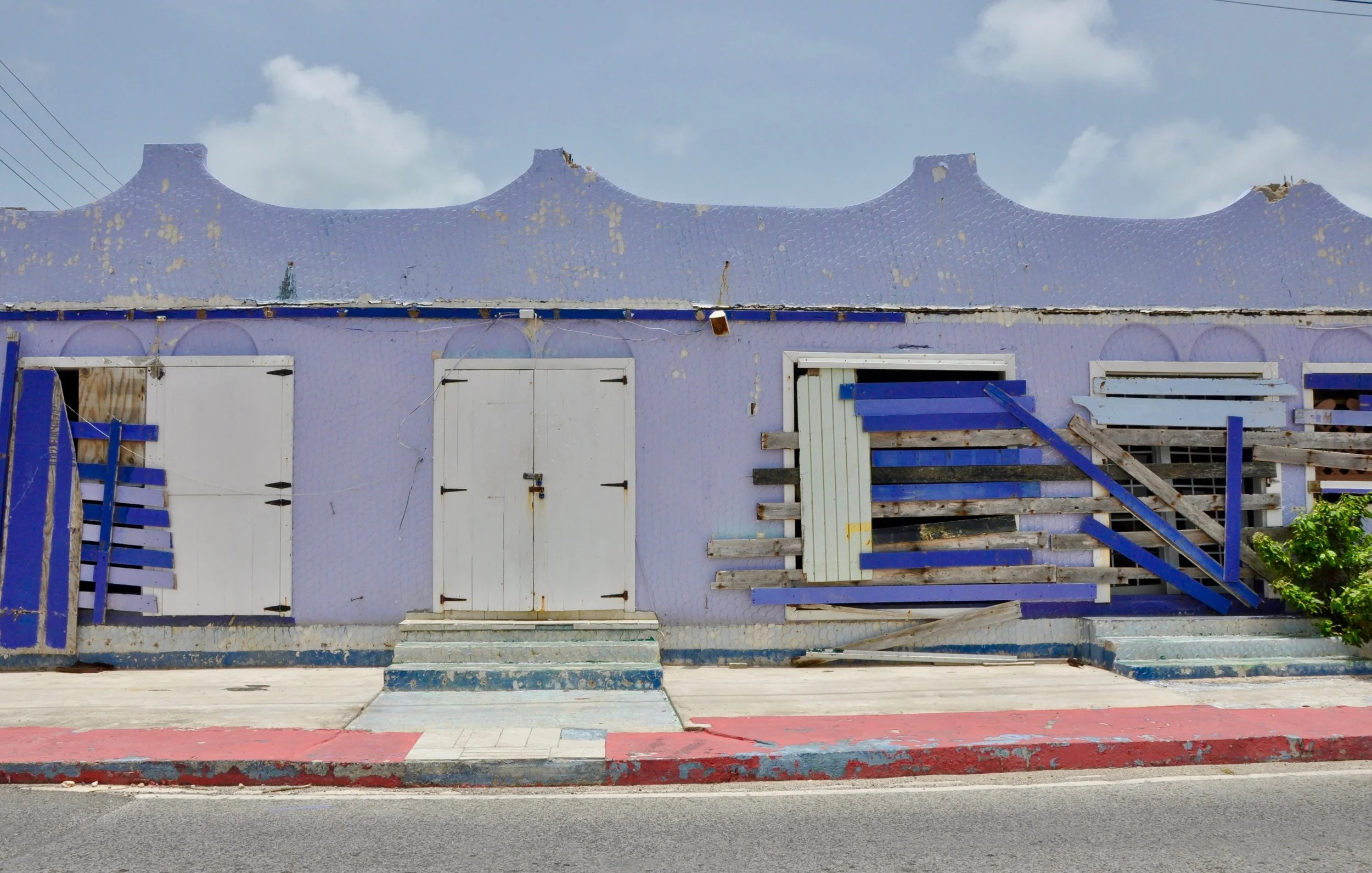 Pretty in purple, there’s a poignant beauty to this building that’s hopefully on the mend. Photograph by Leslie Long.
