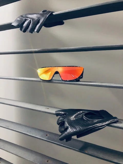 Fingerless leather gloves at Wing & Weft Gloves. Shield styled sunglasses with a sparkle rim that add a special touch for this Summer at Flying Solo . Photography by Crystal Quezada.