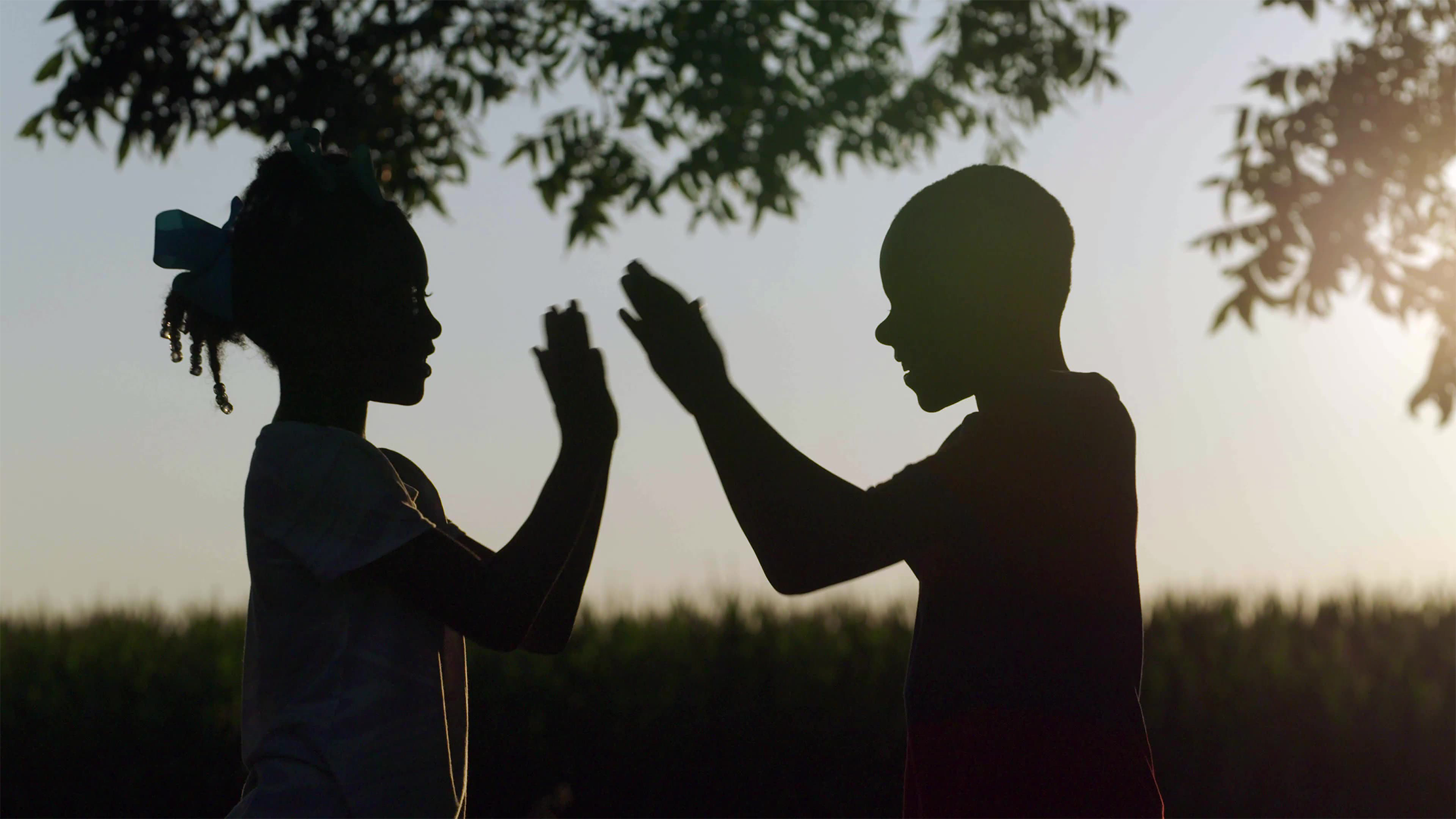 Kids clapping in the fields