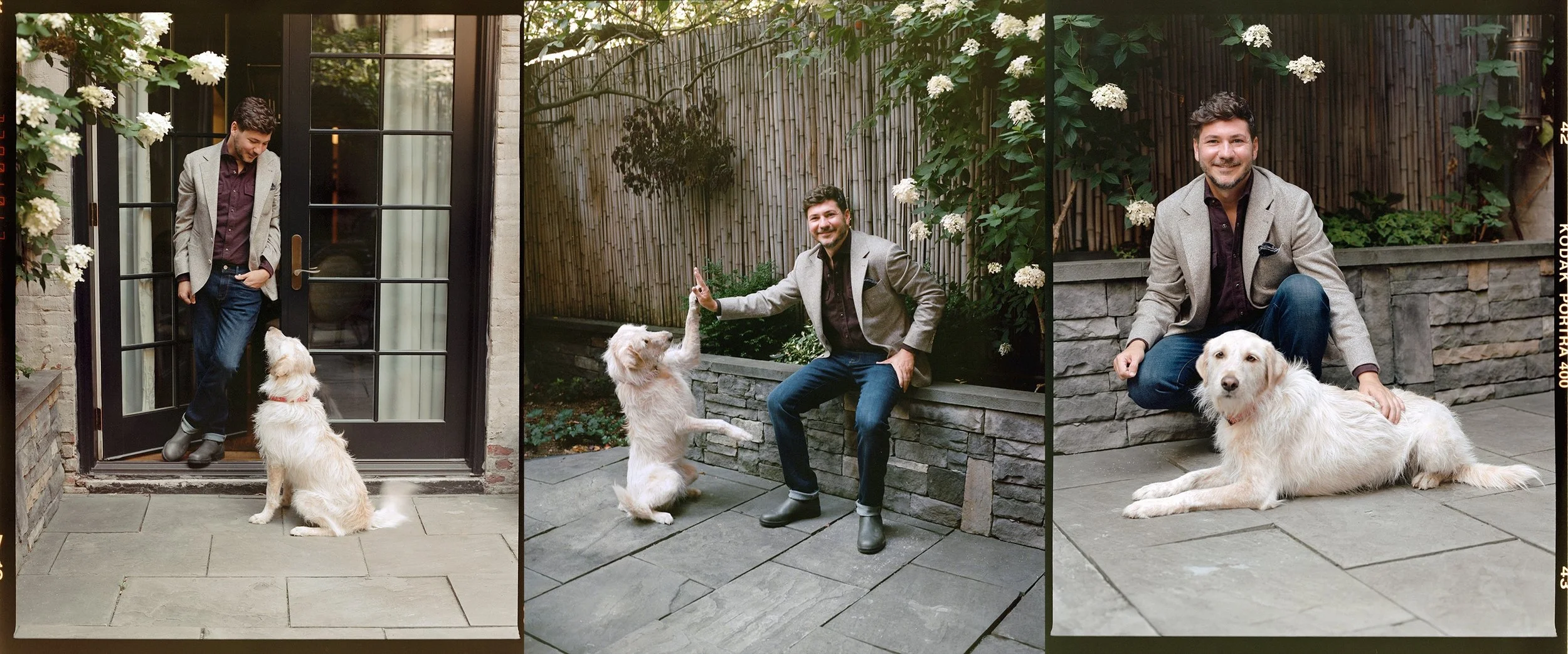 PJ Smith is sitting down with his fluffy white dog.