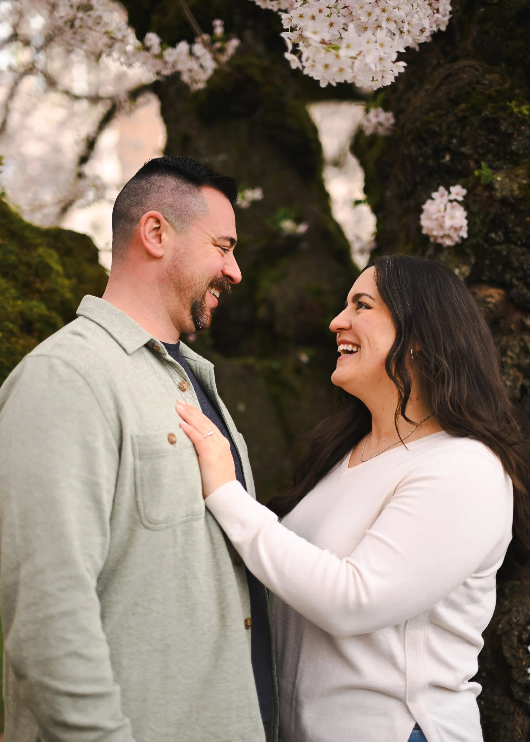 Couple amongst cherry blossoms in Seattle Wa.