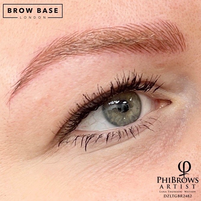 Close-up of an eye with well-groomed eyebrow, black eyeliner, and mascara, with branding for Brow Base London and PhiBrows Artist Lana Thomson-Watson.