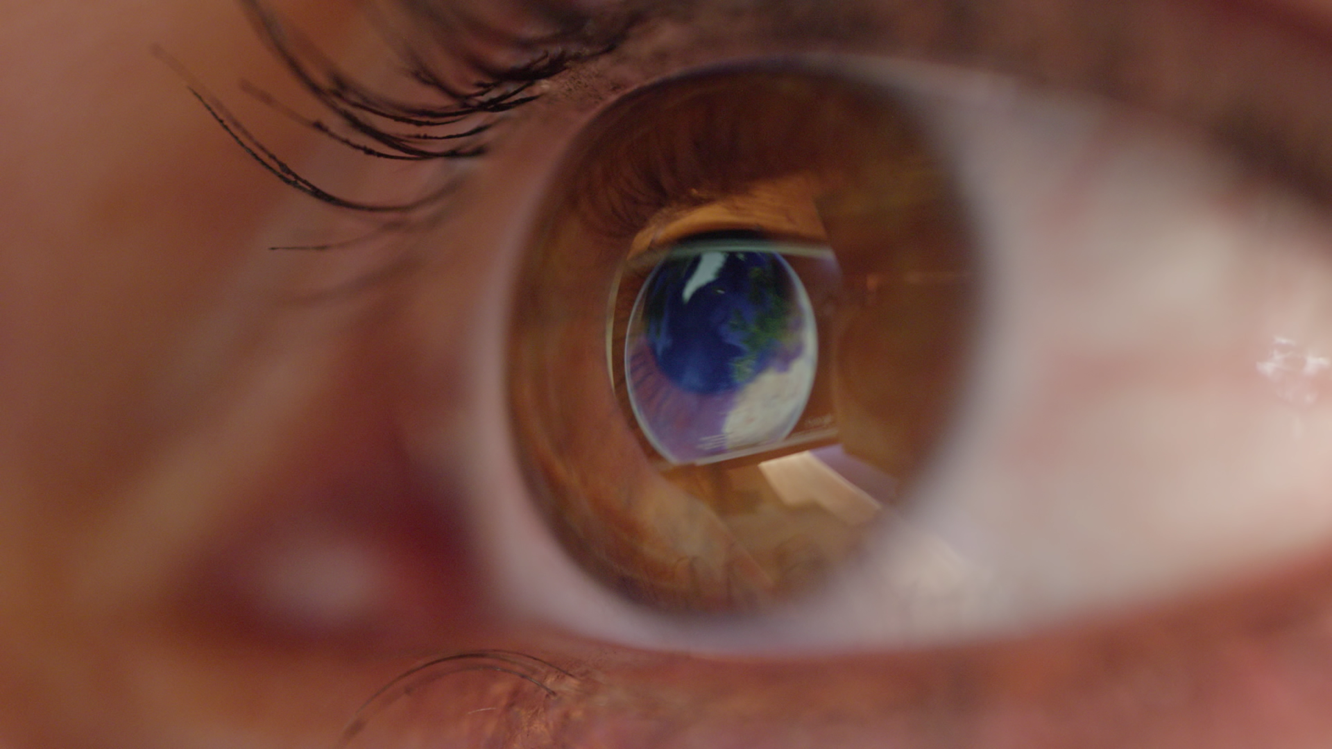videoblocks-macro-close-up-eye-surface-reflecting-the-world-map-showing-on-computer-screen_br_x576bf__D.mov.01_15_37_21.Still001.png