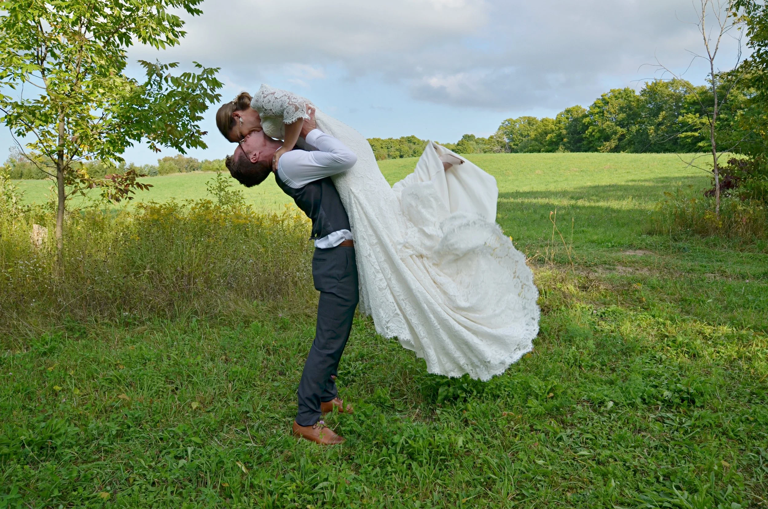 Bride jumping into grooms arms