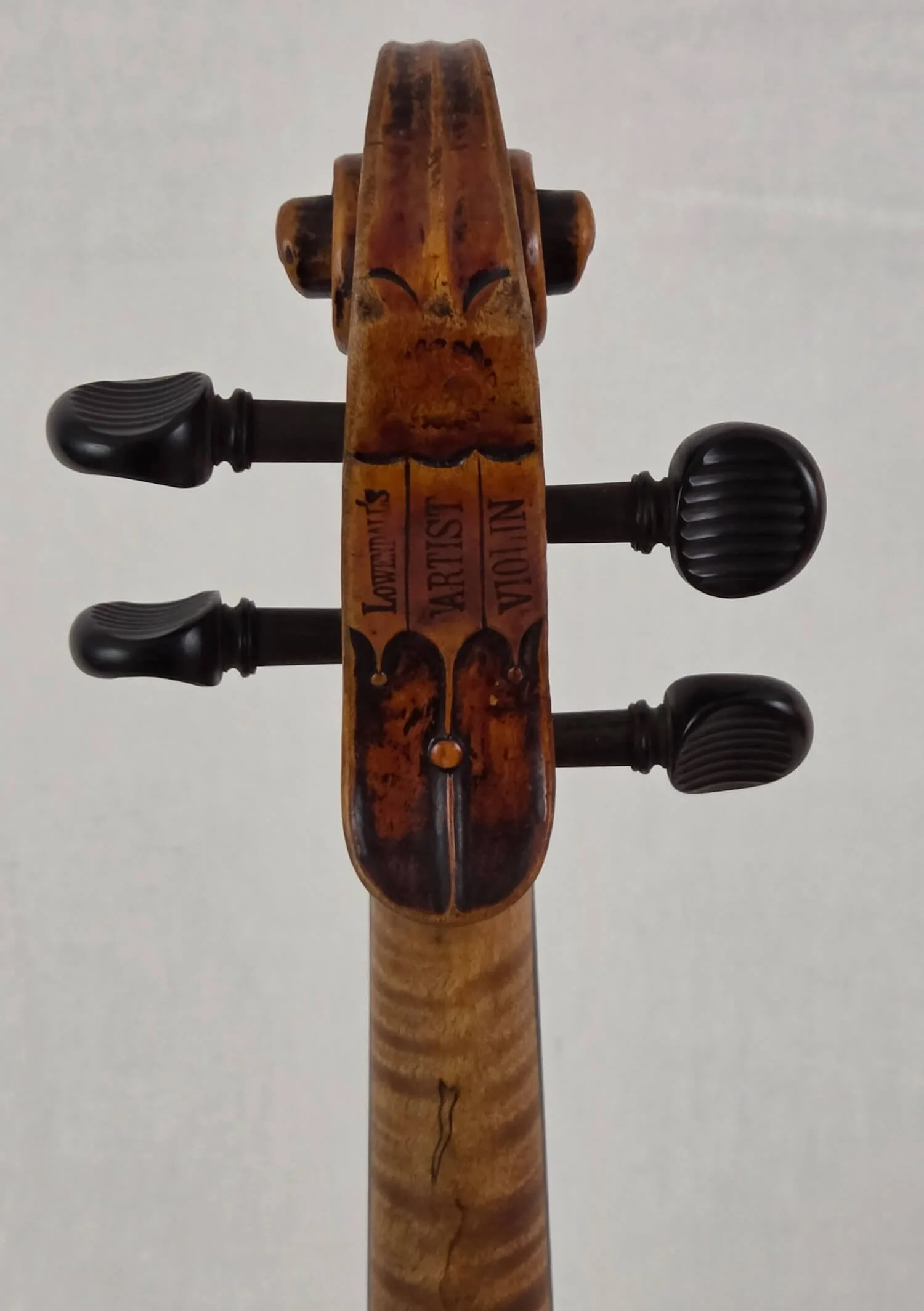 Peg box of a Louis Lowendall violin from 1883.