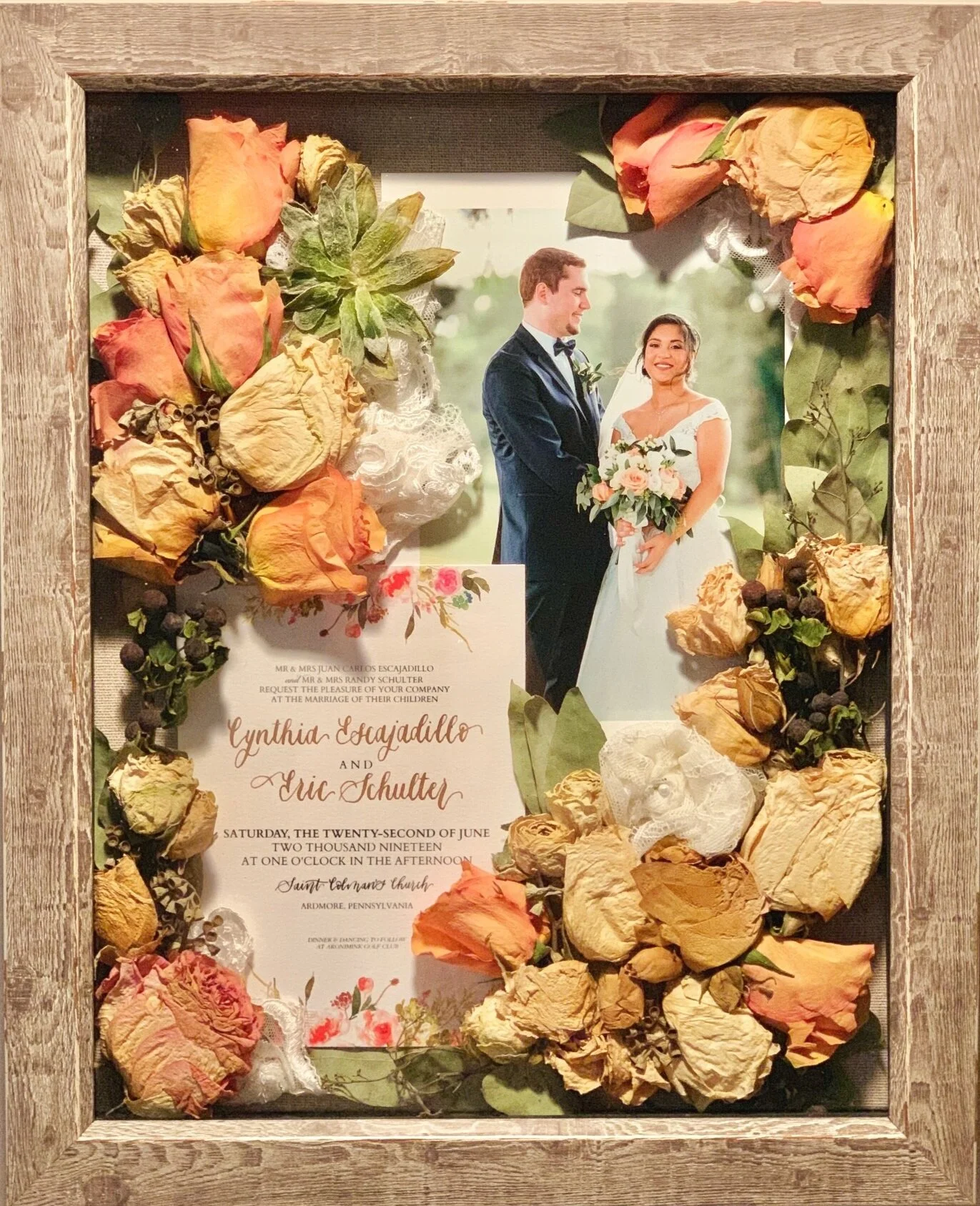 Preserved (not pressed) bouquet from wedding. 11”x 14” reclaimed barn wood frame with 5 x 7 print of bride and groom on the wedding day. Brides can deliver bouquets, invitations, photos, swatches of dress fabric, groom’s boutonnieres, cuff links, etc to be preserved in a frame or hanging shadowbox. See Contact Page to inquire about preserving flowers from weddings, proms, recitals, engagements, funerals, etc. For other examples of work, click here .
