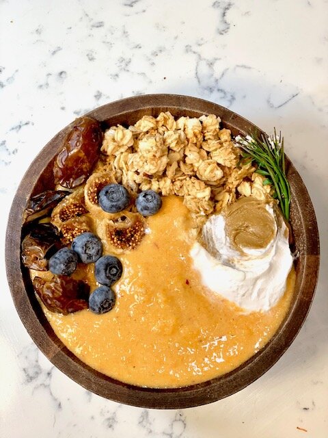 The Autumn Bowl: 2 carrots, 1 banana, 1 apple, 1/2 cup pineapple, 1 inch of ginger (or sub 1/2 tsp ginger powder), 3 inches of turmeric, 3/4 cup almond milk, 3 tablespoons maple syrup. Topped with dried figs, dates, sunflower butter, maple granola, vegan yogurt, and blueberries.