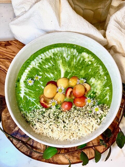 The Gardener: 1 frozen banana, 1/2 mango, 1 cup spinach, 1/4 cup frozen coconut chunks, 1/2 cup almond milk, topped with vegan yogurt, Ranier cherries, shredded coconut, hemp hearts, and chamomile flowers.