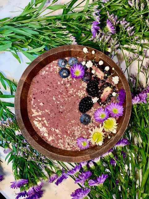 The Early Riser: 1 banana, 1/2 cup strawberries, 1/4 cup blueberries, 1/4 cup beet, 1/2 carrot, 1/2 cup blackberries, 1/2 cup oat milk, topped with blackberries, blueberries , and hemp hearts.