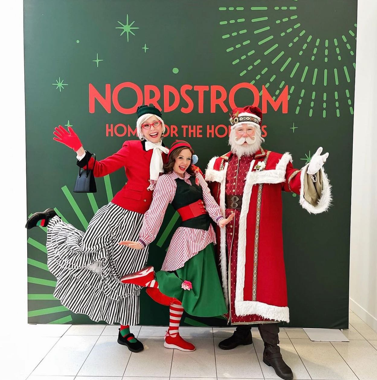 Nordstrom with one of five Santas and one of many elves, 2023