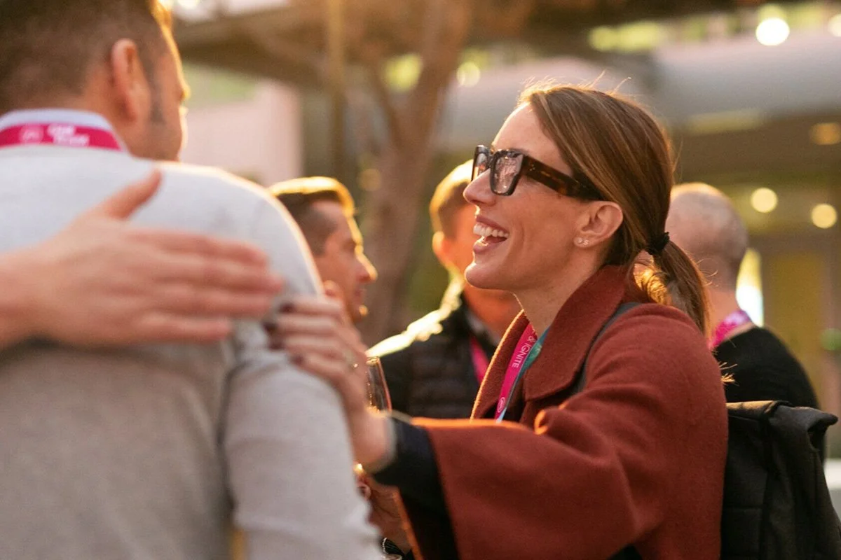 Event photography and candid moment of  and EA employee smiling during an Electronic Arts all-hands corporate conference in Redwood City, Silicon Valley