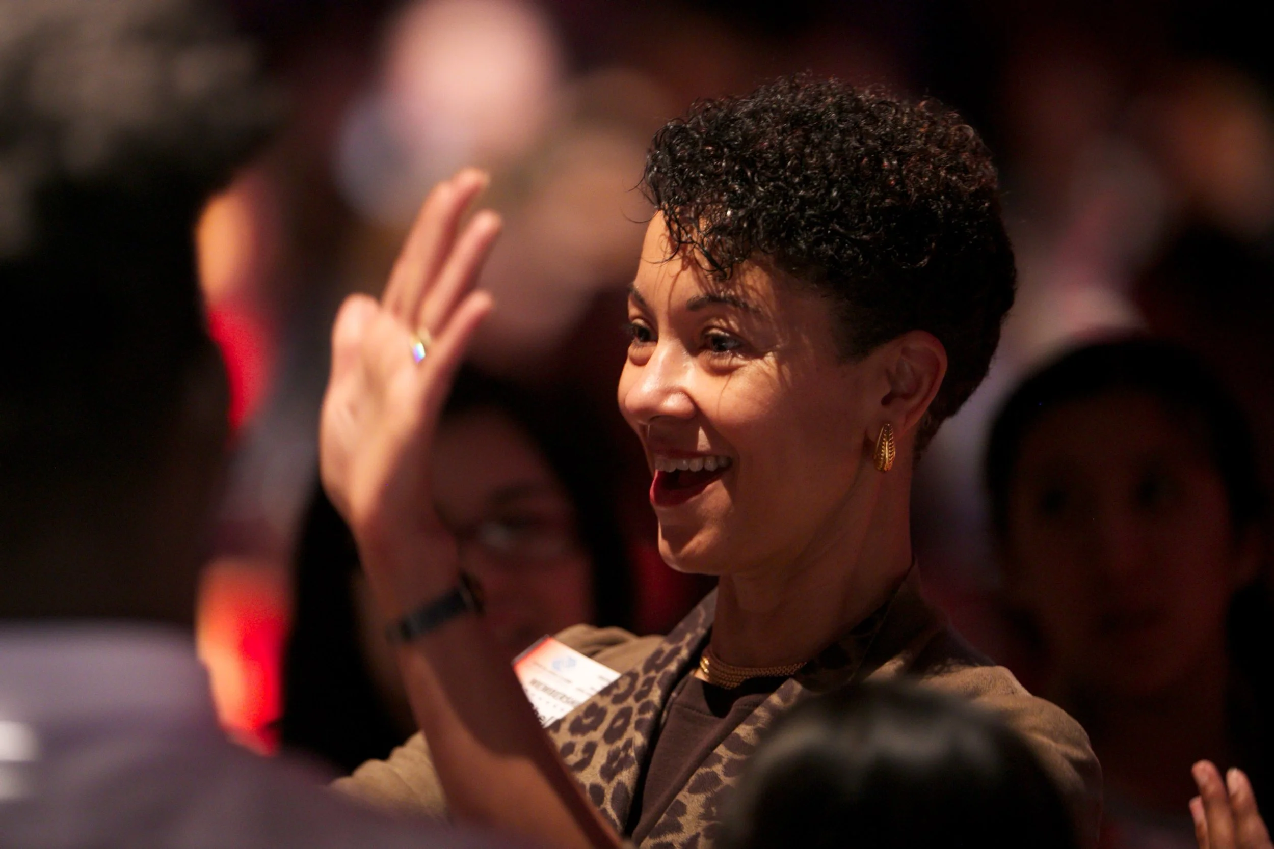 Shellye Archambeau, CEO of MetricStream, giving high-fives to an energetic audience