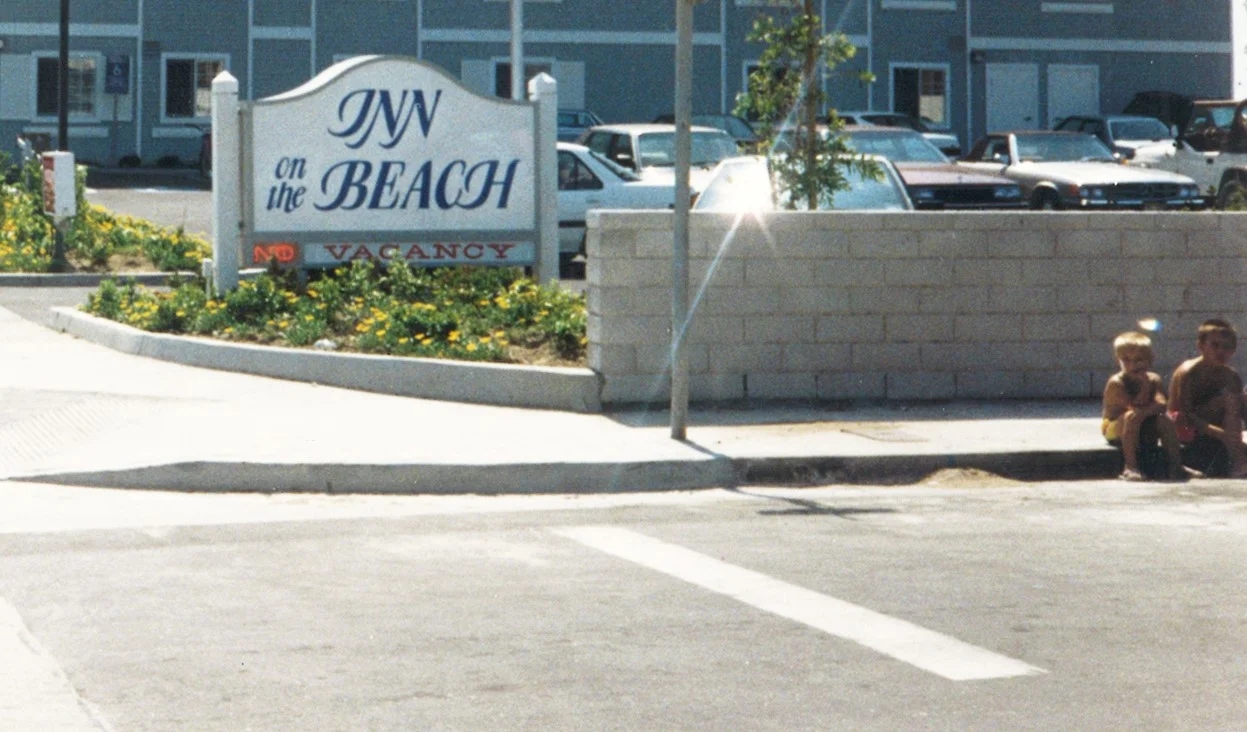 2. Chris and Jay sitting on curb at Inn on the Beach.jpg