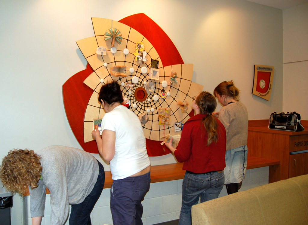  Connection Web: 6’ 4” x 5’ 9” x 2” Baltic birch and cherry wood ply, Delrin, aluminum, Corian, porcelain with decals, steel and polycarbonate locking mechanism :: 2009.  As part of our commitment to the community center, we set up a teaching interns