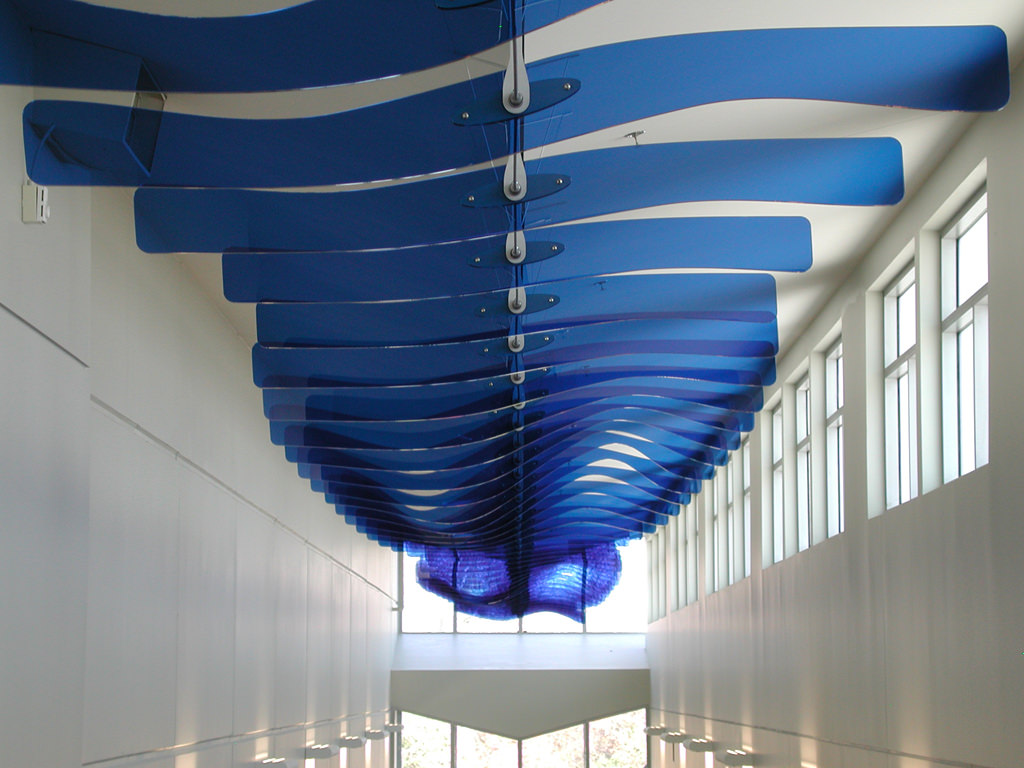  Ripple Effect: 3’ x 6’ x 150’ Acrylic fins, steel, aluminum, sensors, controllers and stepper motors :: 2009.  This sculpture uses two passive infrared motion sensors, one at either end of the installation, each of which is connected to a stepper mo