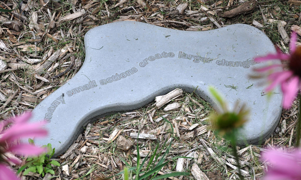  KCAI Brush Creek Community Rain Garden, Kansas City, MO :: 2006-present.  Close up text stone – many small actions create larger changes. Cast cement stones were designed and made by one of the students, and many participated in choosing the texts t