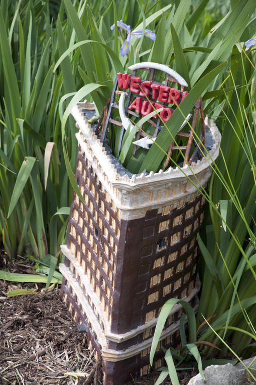 KCAI Brush Creek Community Rain Garden, Kansas City, MO :: 2006-present.  Sculpture in the garden. This is a model of a landmark building from downtown Kansas City, with its highly visible signage. The student wanted the vegetation to grow up throug