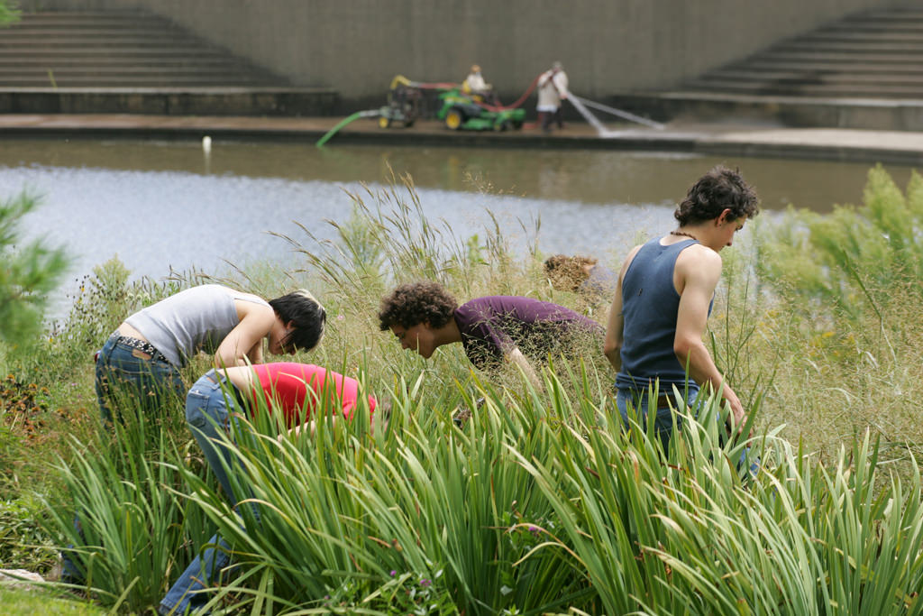  KCAI Brush Creek Community Rain Garden, Kansas City, MO :: 2006-present.  Students weeding with a clean up crew in the background. This image shows both the problem and its remediation, as young people come to understand how they can invent and impl