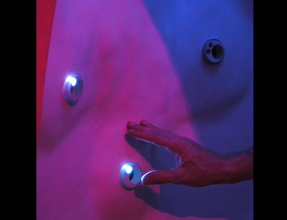  Poetry Machine: 7’ 6” x 4’ x 4’. Expanded foam, Aqua resin, sensors, battery power, microprocessors, computer and sound systems, Seattle, WA :: 2005.  There are 28 sensor buttons embedded into the inner walls of this aqua resin-coated booth structur