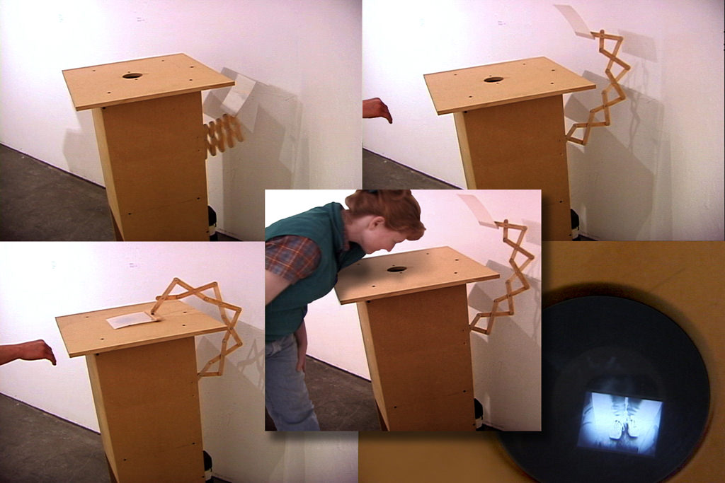  Now You See It: 5’ x 18” x 2’. Optical sensor, microprocessor, servo motor, tongue depressors, particle board, video camera &amp; display, Stranger exhibit at the CMA Gallery, Seattle WA :: 2003.  This interactive sculpture uses simple technology an
