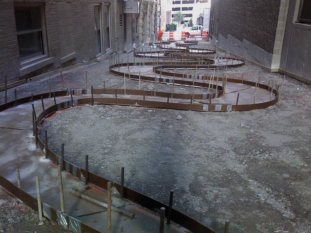  The Commons, downtown Kansas City :: 2012.  Alley from the rear, with the stream template and forms in place. The concrete crew was then able to set the forms tightly to the curves we specified. There was still some flattening that happened in small