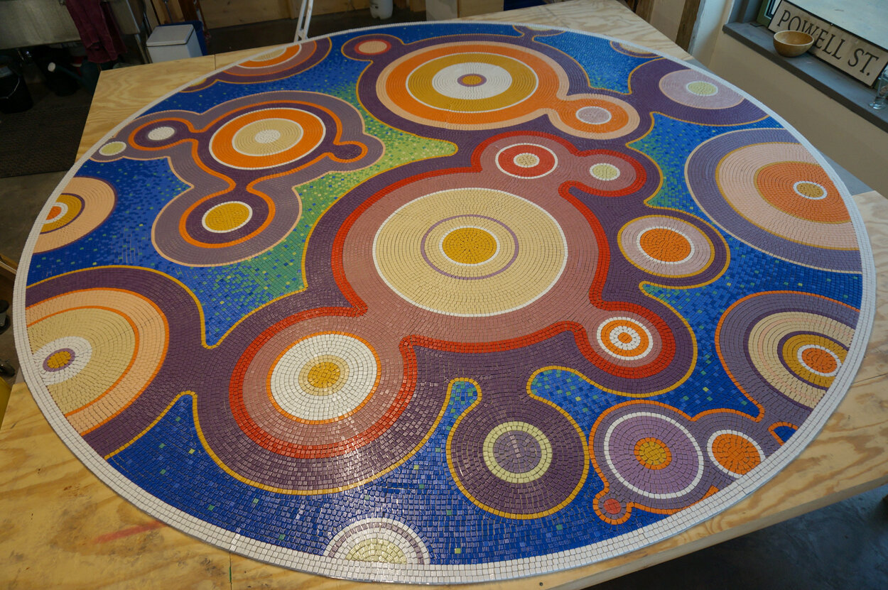                   The Exchange, KU Edwards, Overland Park, KS :: 2017.    The mosaic was then assembled in our studio. It was created in pie-shed wedges that were then assembled together, a process that was facilitated by mounting the tiles upside do