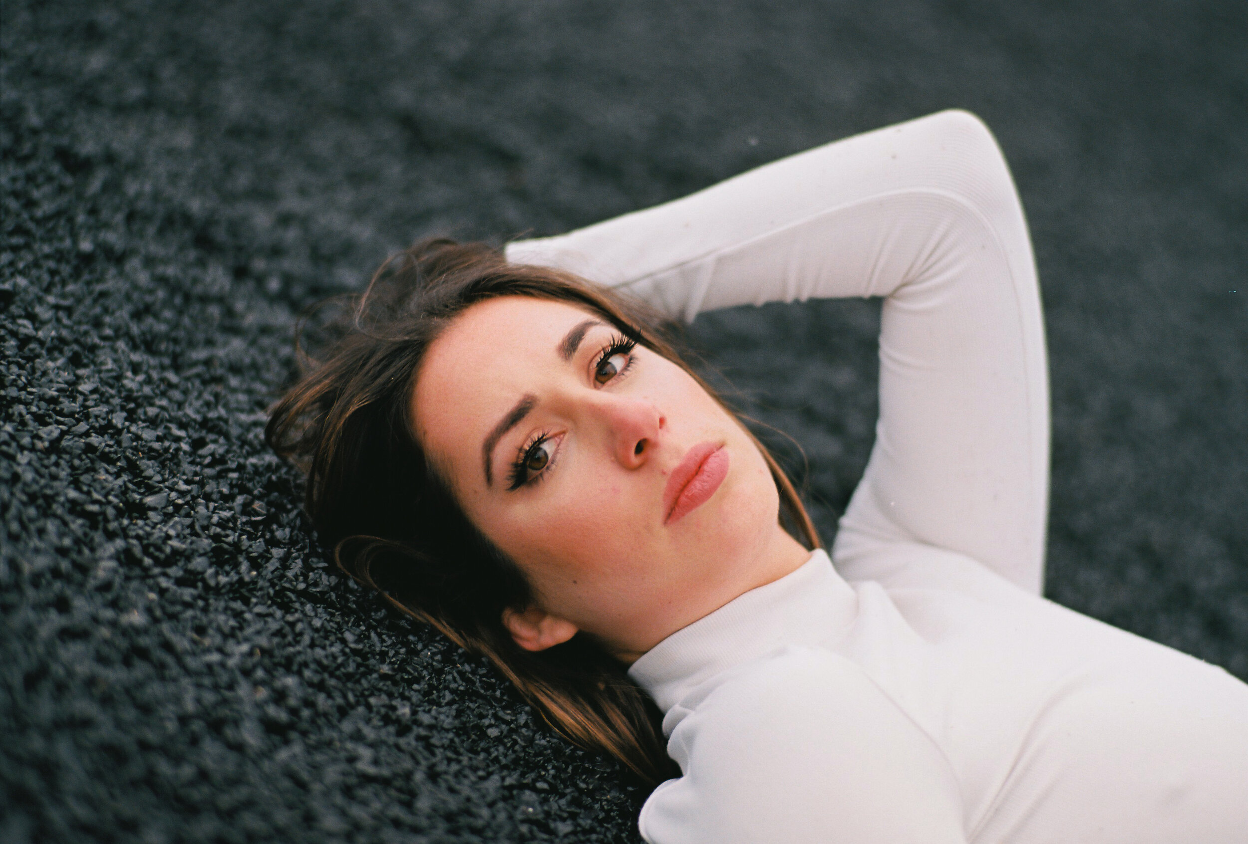 Portrait of Woman in White on Black Asphalt