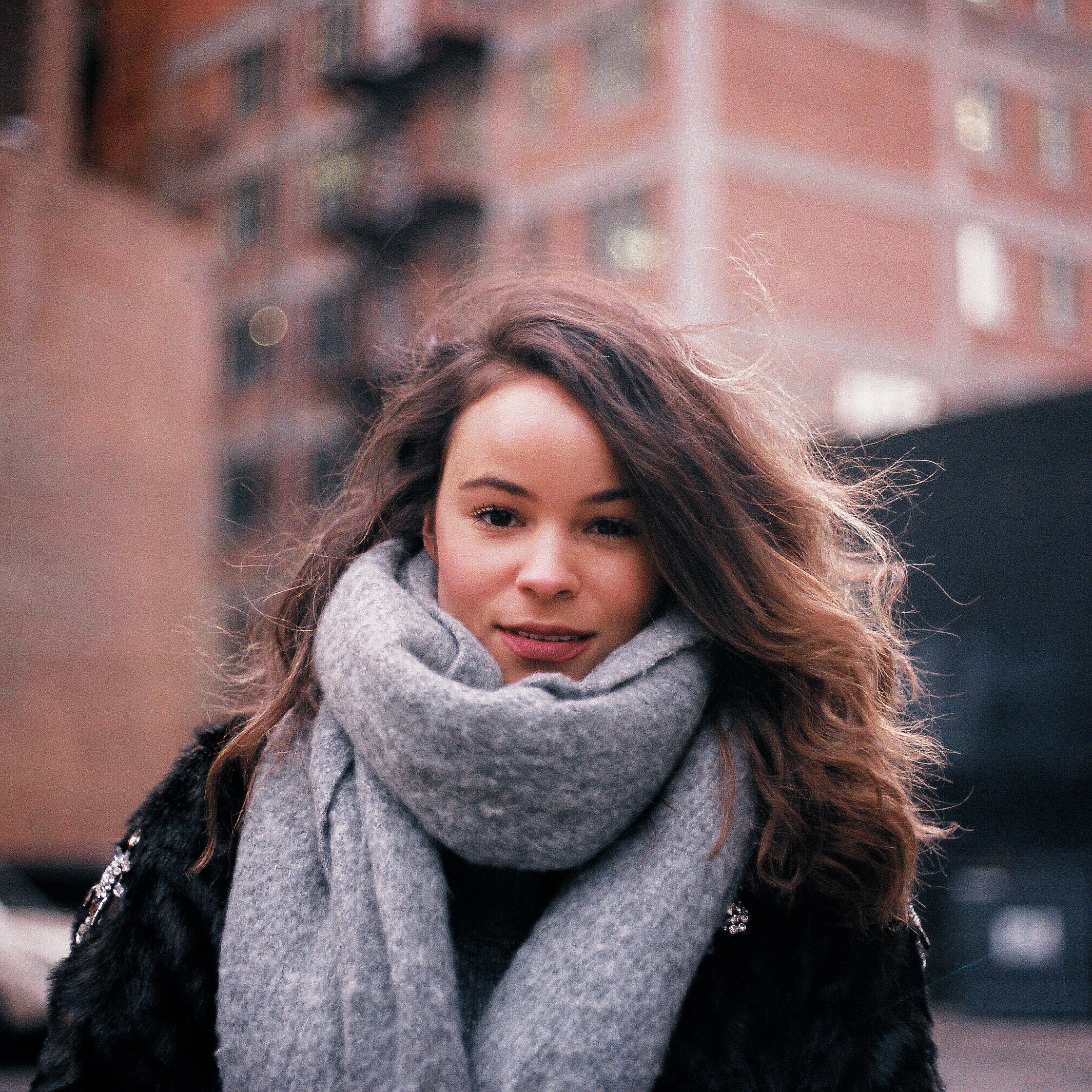Portrait of Woman Red Brick Grey Scarf