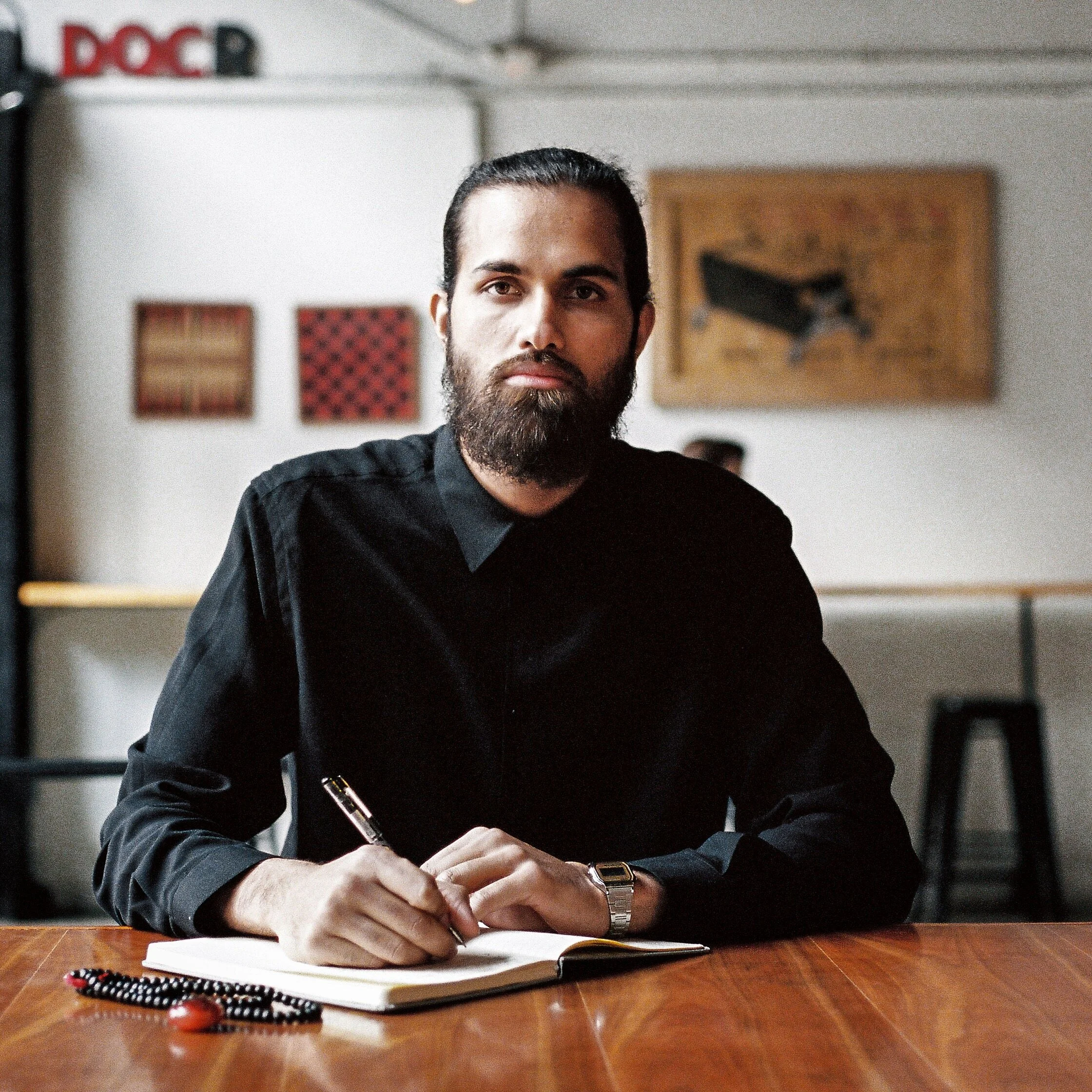 Portrait of man writing in cafe