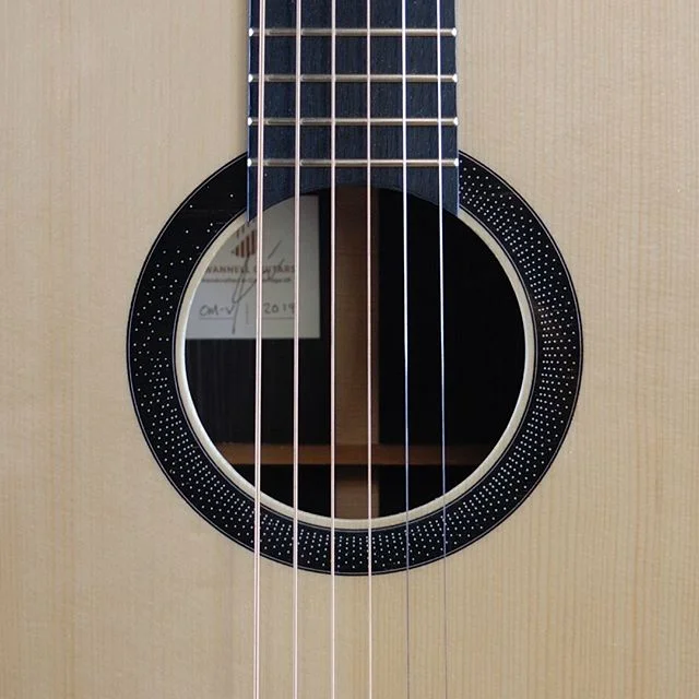 The dotty rosette with strings on. I'm very happy with how this turned out. 
#acousticguitar #ngd #newguitarday #rosette #strings #guitar #soundhole #dotty #geometricdesign #geometry #pattern #cnc #luthier #guitarmaker #makespace