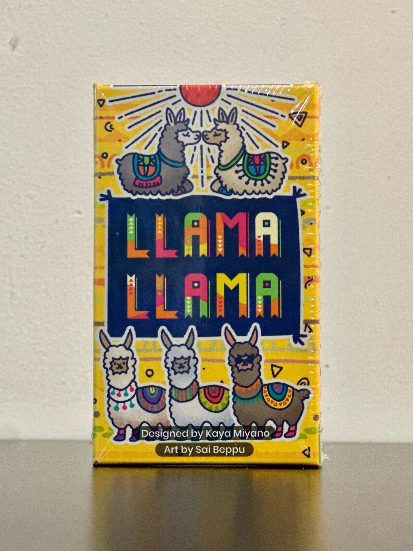Score hands based on secretly chosen goal cards! 🦙
&bull;
&bull;
&bull;
In Llama Llama, players pass cards to craft hands around the different scoring conditions. These conditions were chosen by the players secretly at the start of the round&mdash;y