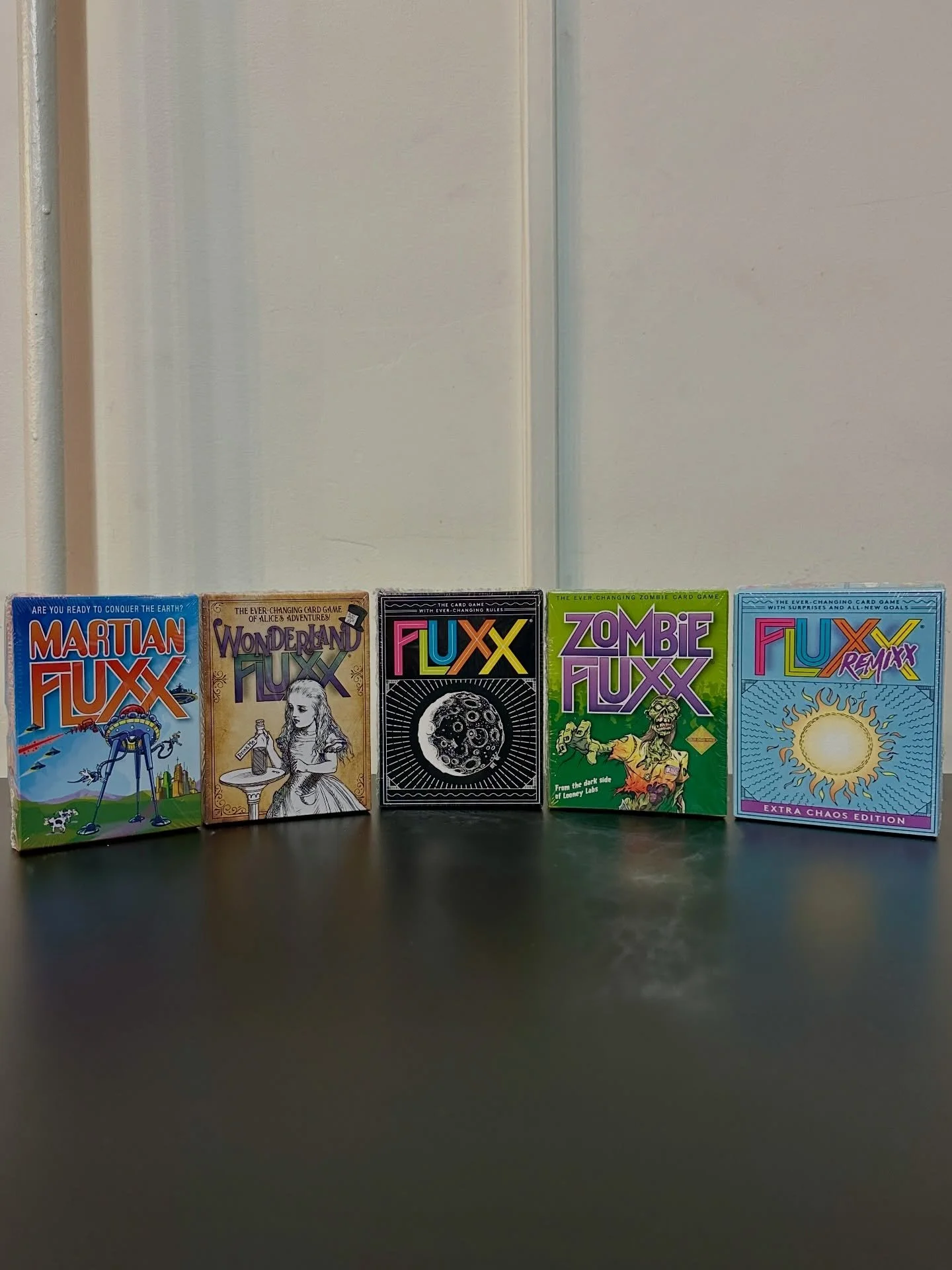 Play cards and alter the rules in this ever changing card game! 🌑
&bull;
&bull;
&bull;
Fluxx is a card game in which the cards themselves determine the current rules of the game. By playing cards, you change numerous aspects of the game: how to draw