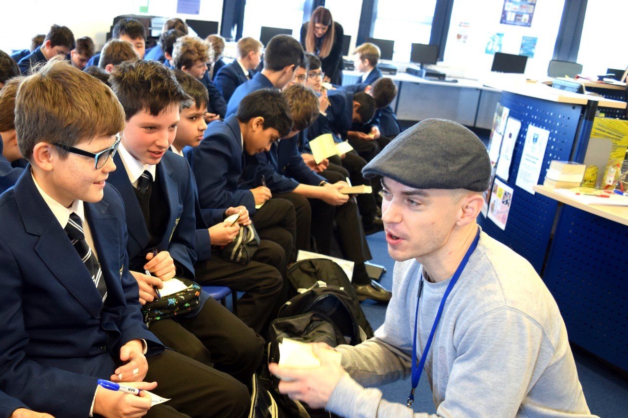 Andy crouching with student audience.jpeg