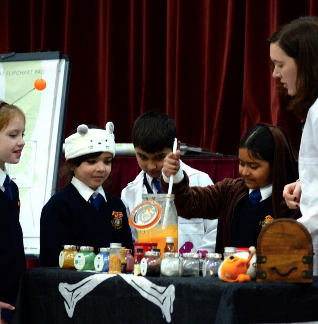 Chrissie running science experiment with pupils.png