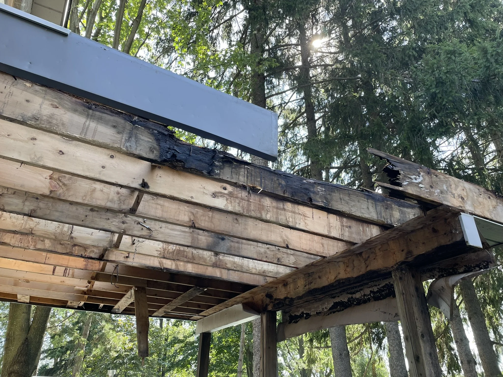 Rotting deck framing caused by trapped moisture