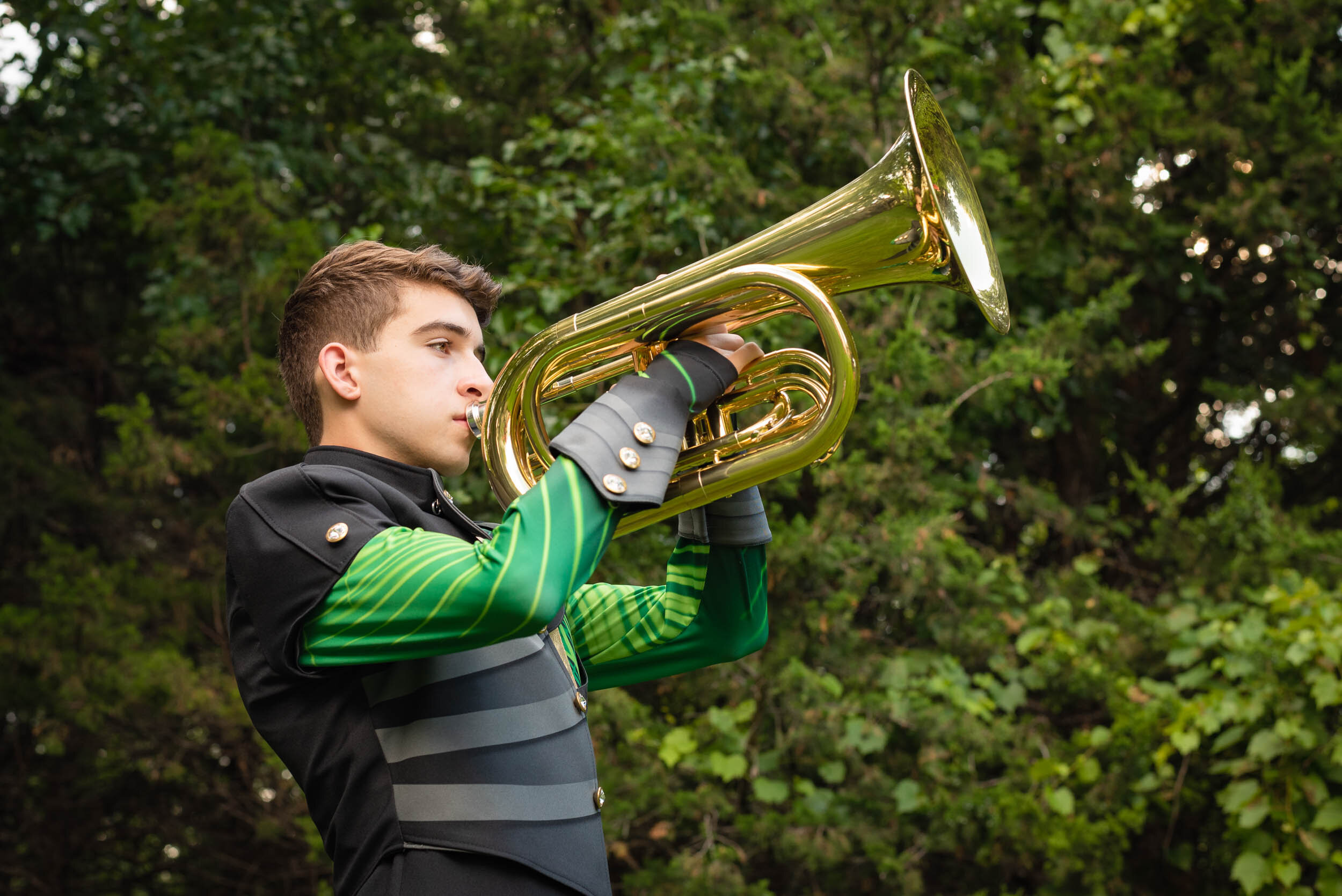 senior-guy-green-black-band-uniform-baritone-outside-musical-instrument-Jill-Carson-Photography.jpg