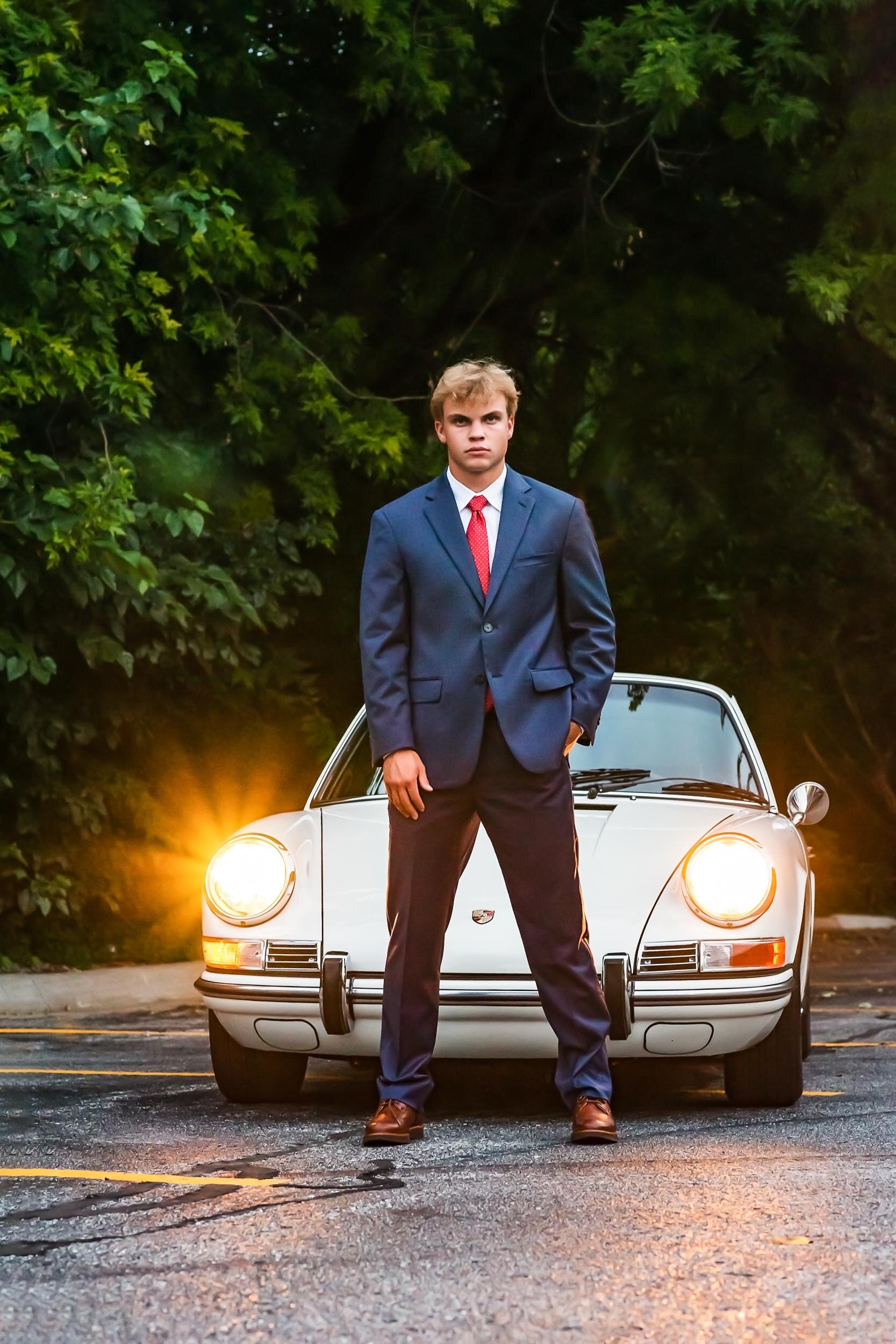 senior-guy-serious-porsche-vintage-car-headlights-Jill-Carson-Photography.jpg