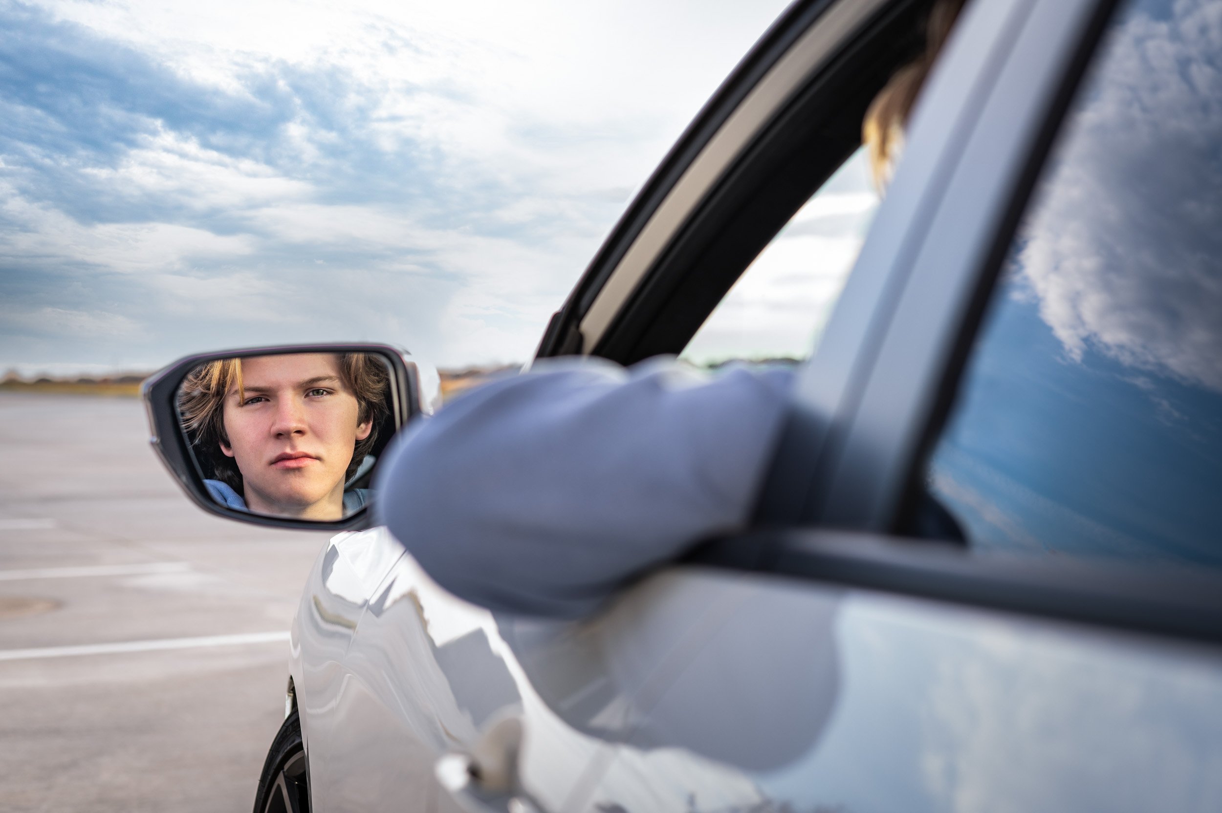 senior-guy-looking-in-mirror-car.jpg