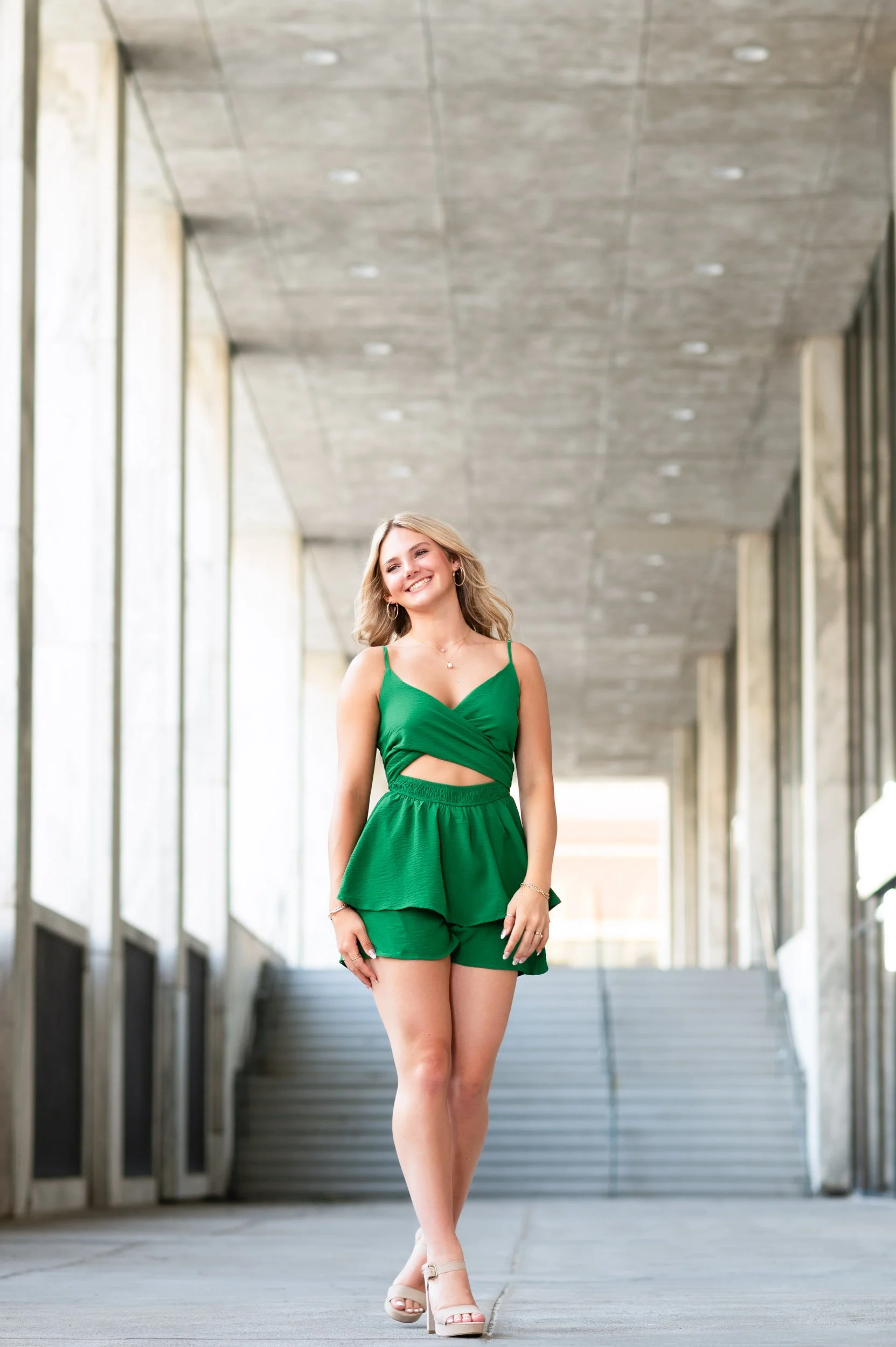 senior-girl-green-romper-walking-corporate-breezeway.jpg