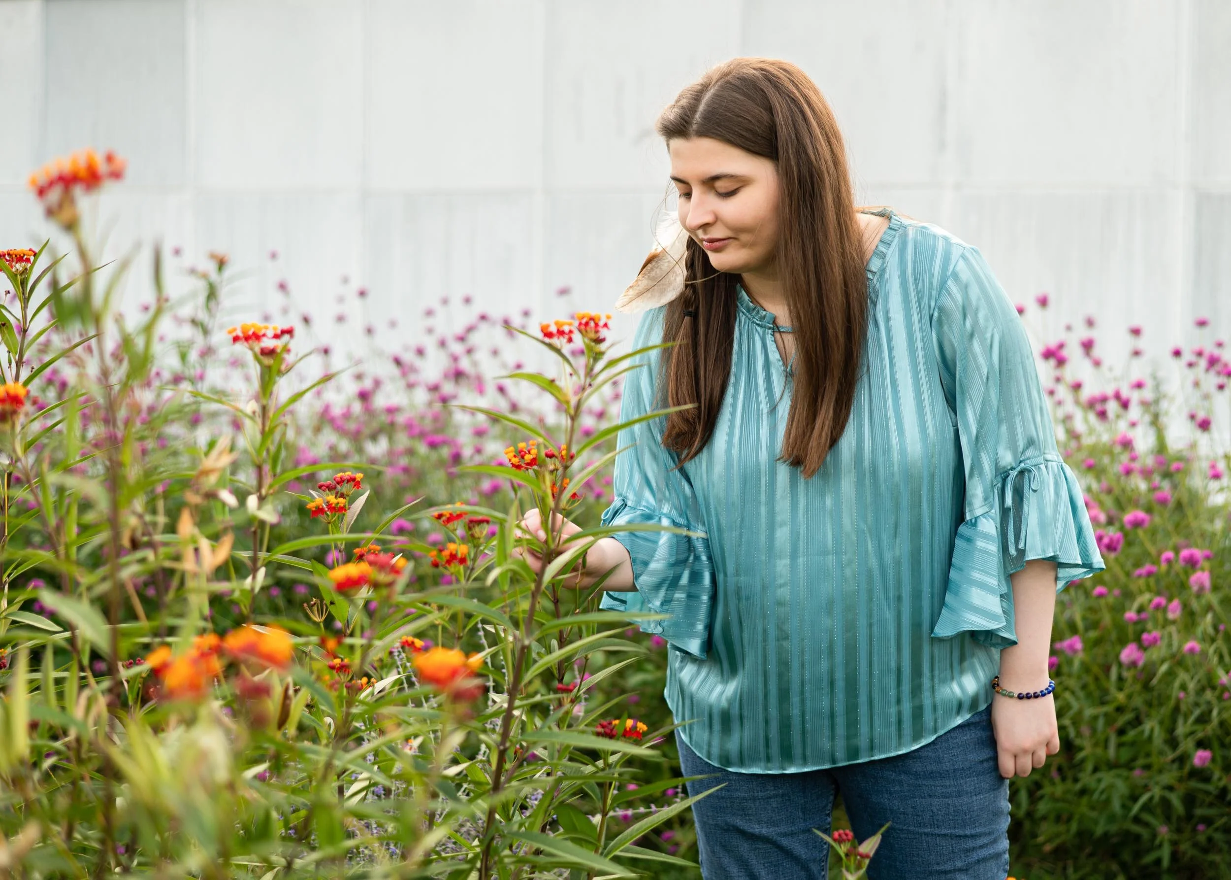 senior-girl-looking-at-wild-flowers.jpg