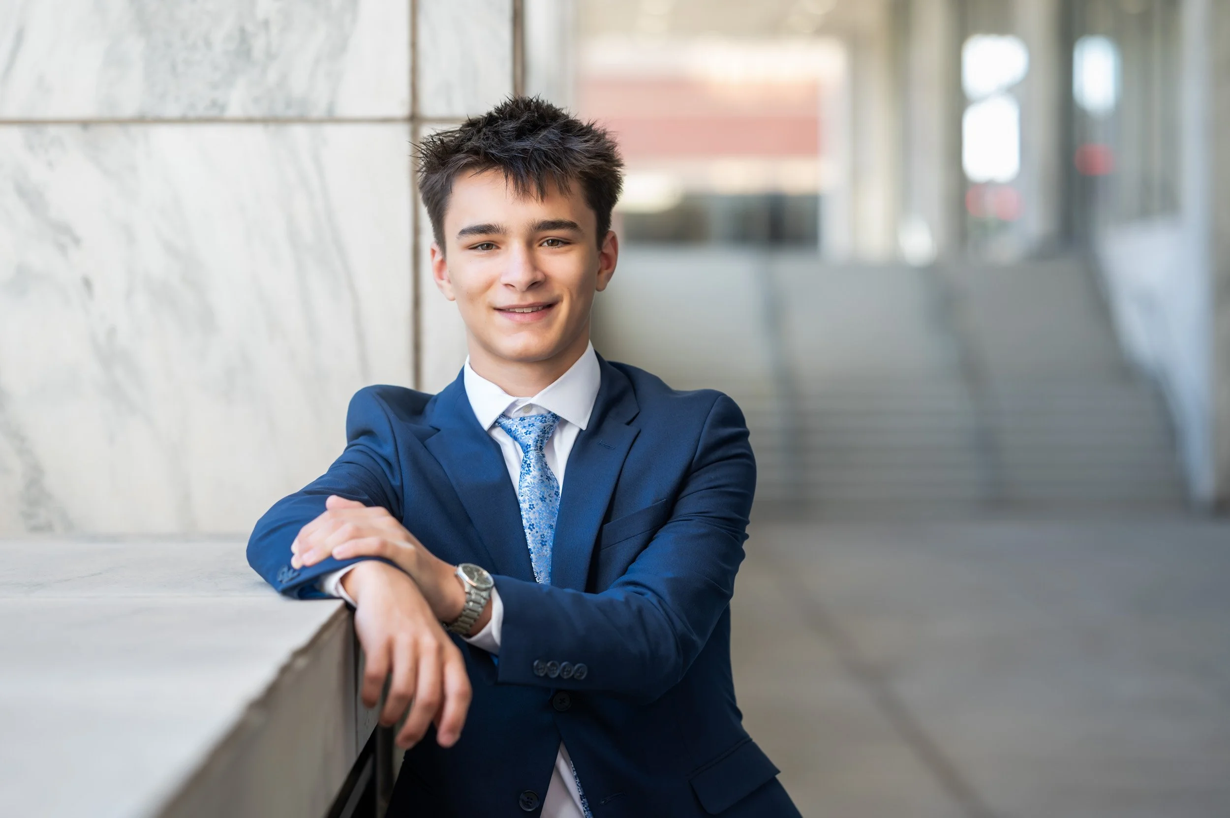 senior-guy-navy-suit-white-marble.jpg