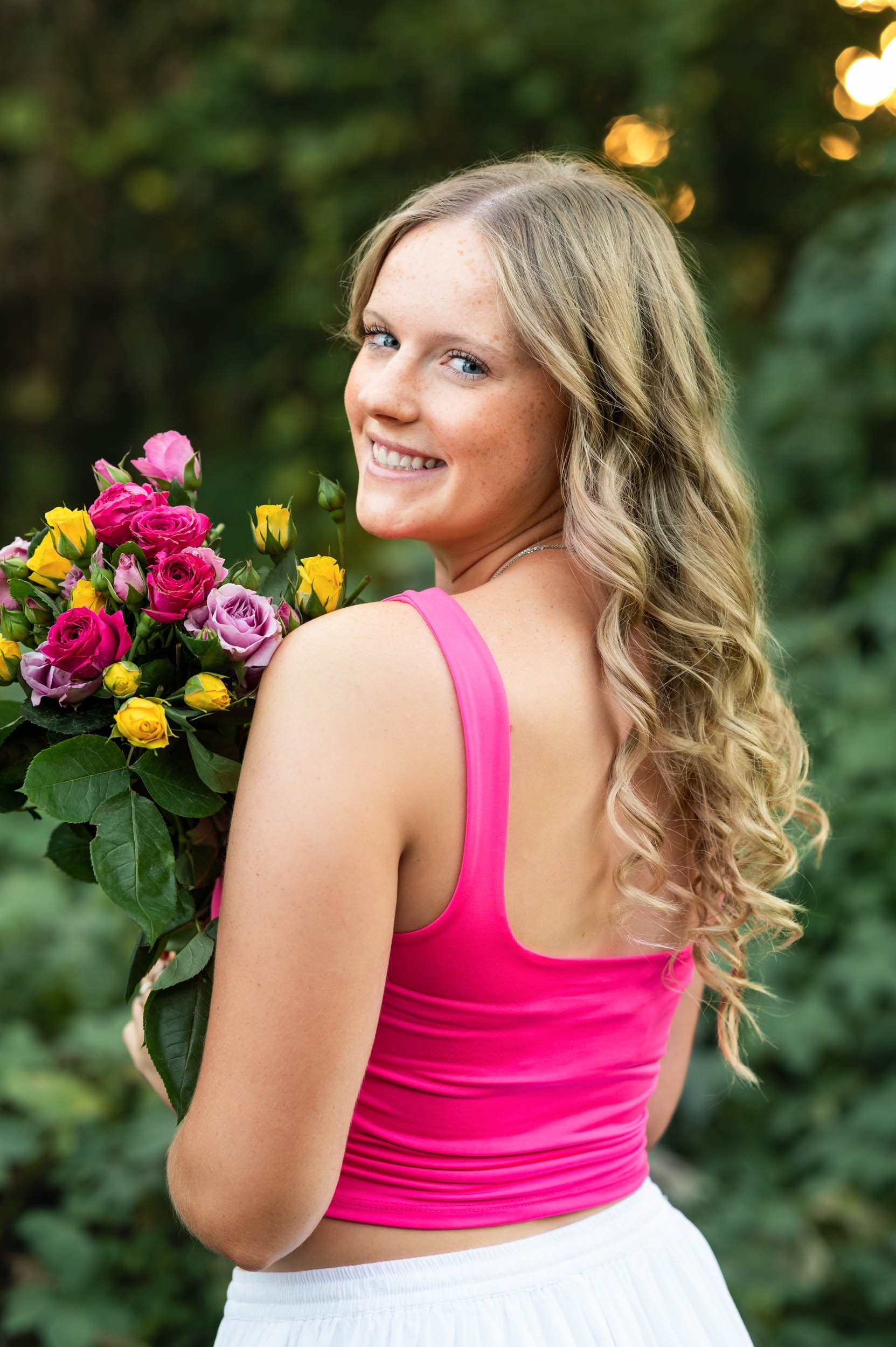 senior-girl-over-shoulder-green-foliage.jpg