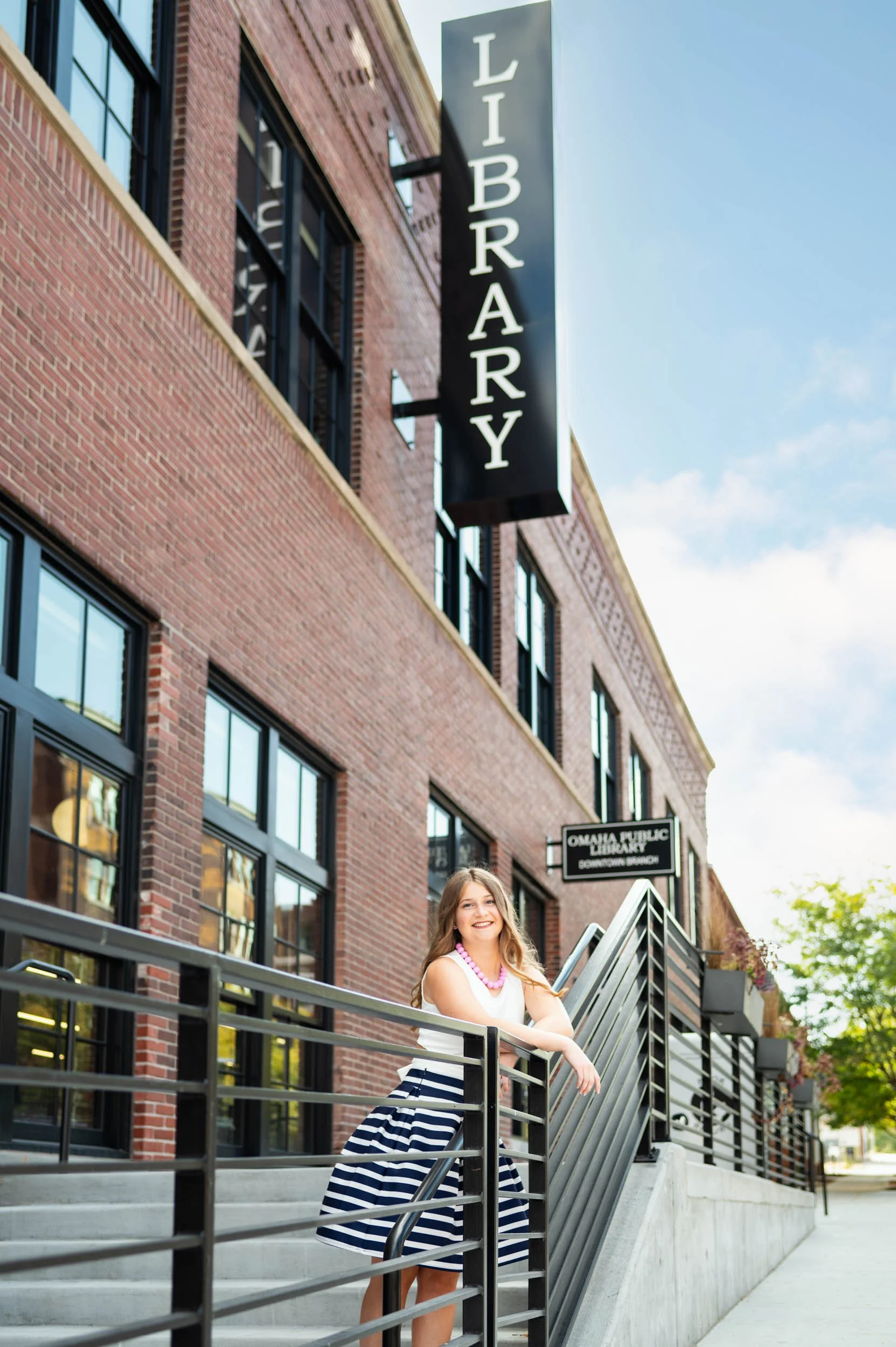 senior-girl-exterior-omaha-public-library-vertical.jpg