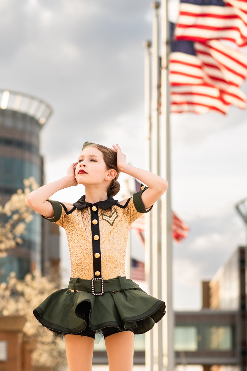 omaha-tap-dancer-in-army-uniform-with-american-flags-in-background-Jill-Carson-Photograpy-Omaha-Nebraska.jpg