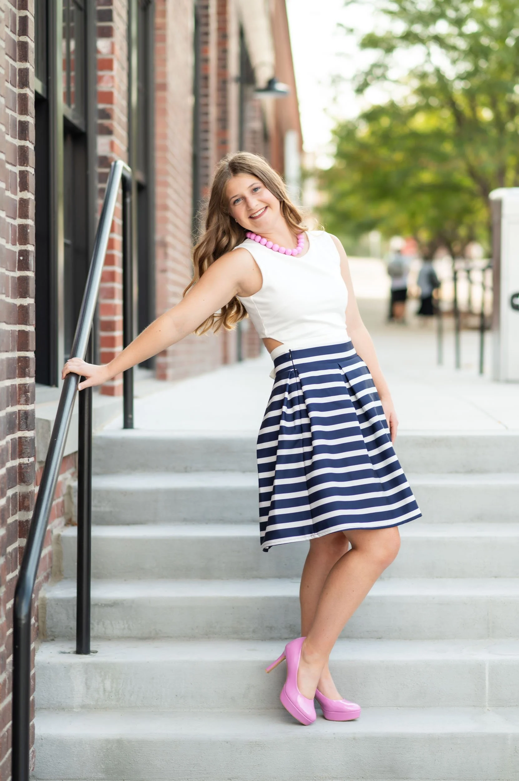 senior-girl-exterior-omaha-public-library-railing.jpg