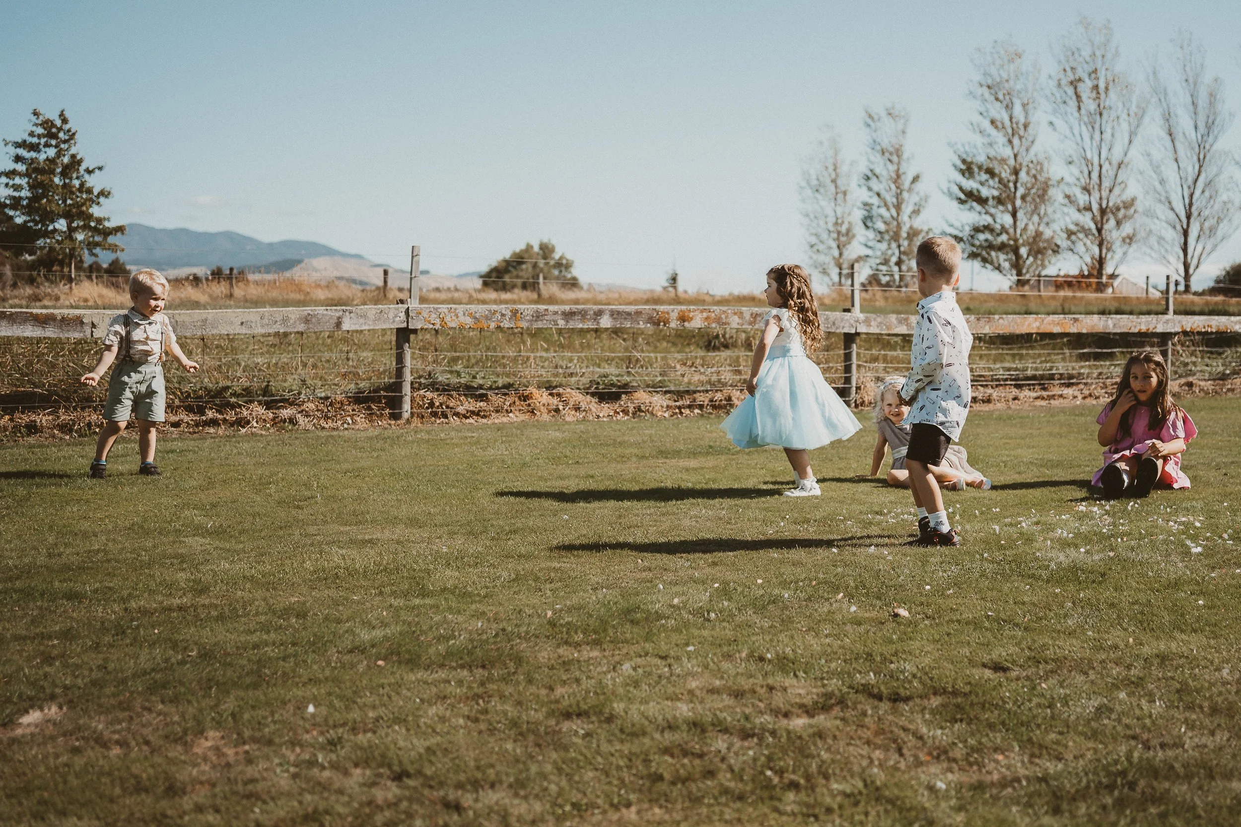 Kids playing a game together on the lawn
