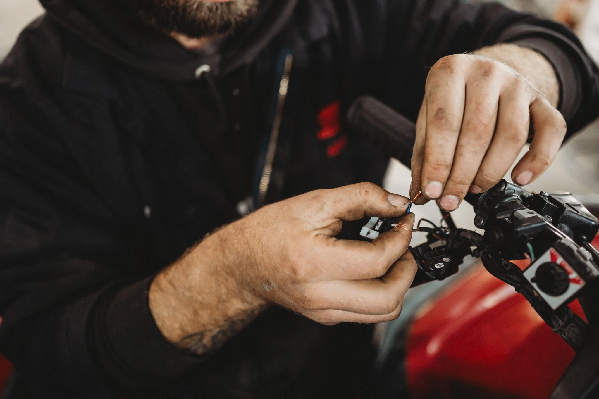 Close up image of hands working on motorcycle
