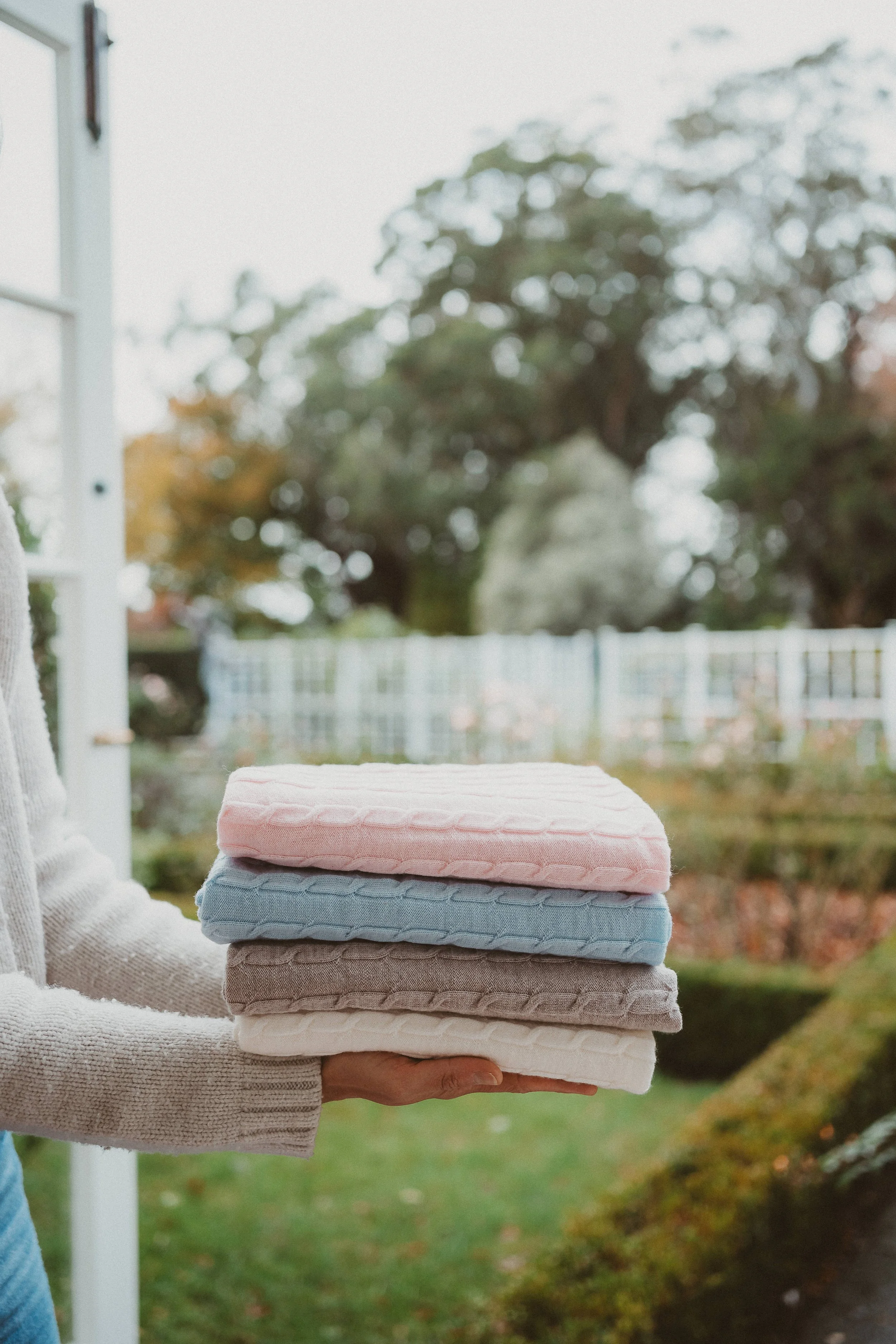 Image of a stack of blankets on palms.