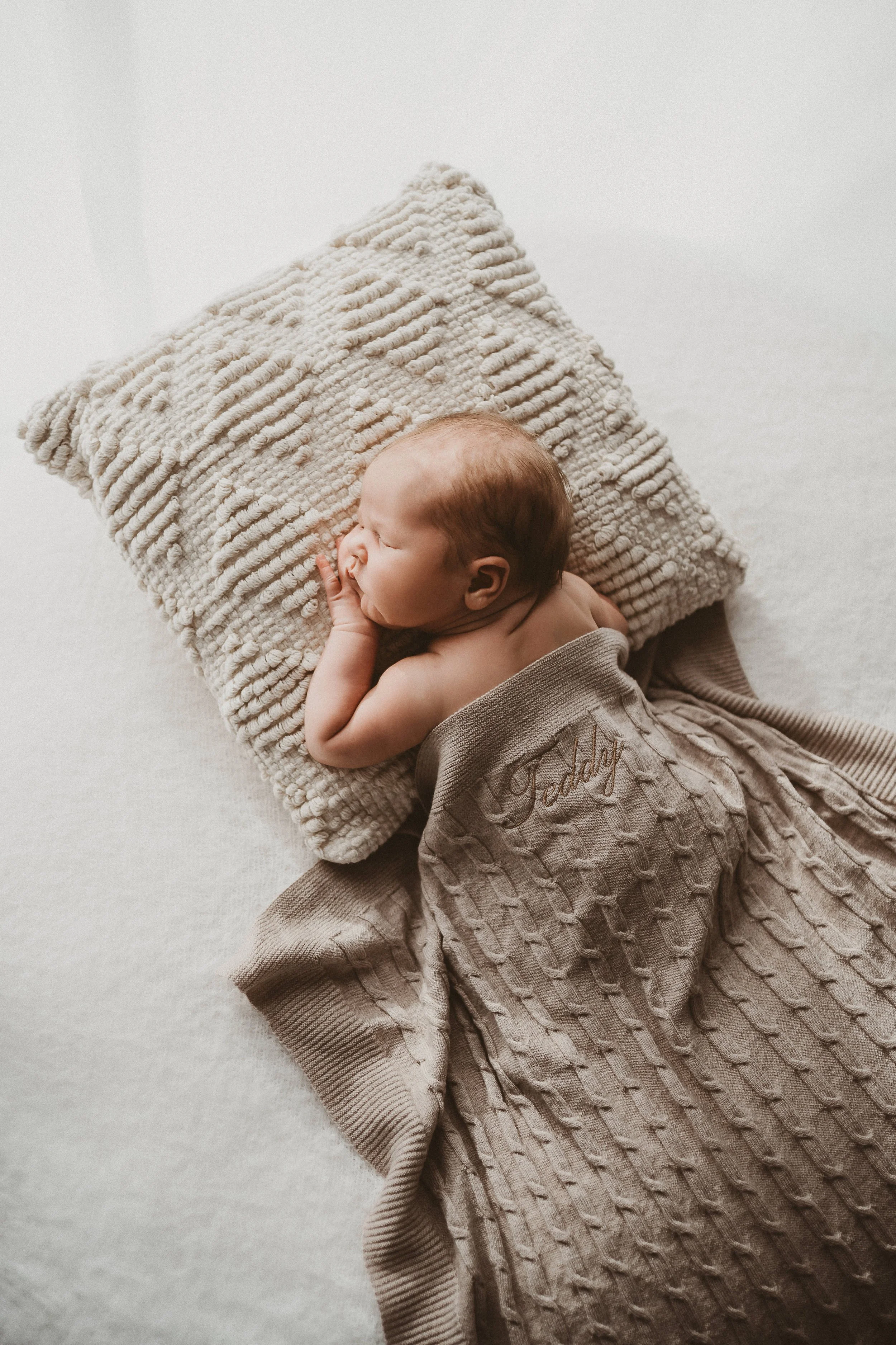 Blanket on a baby. Product photo for Wairarapa embroidery business