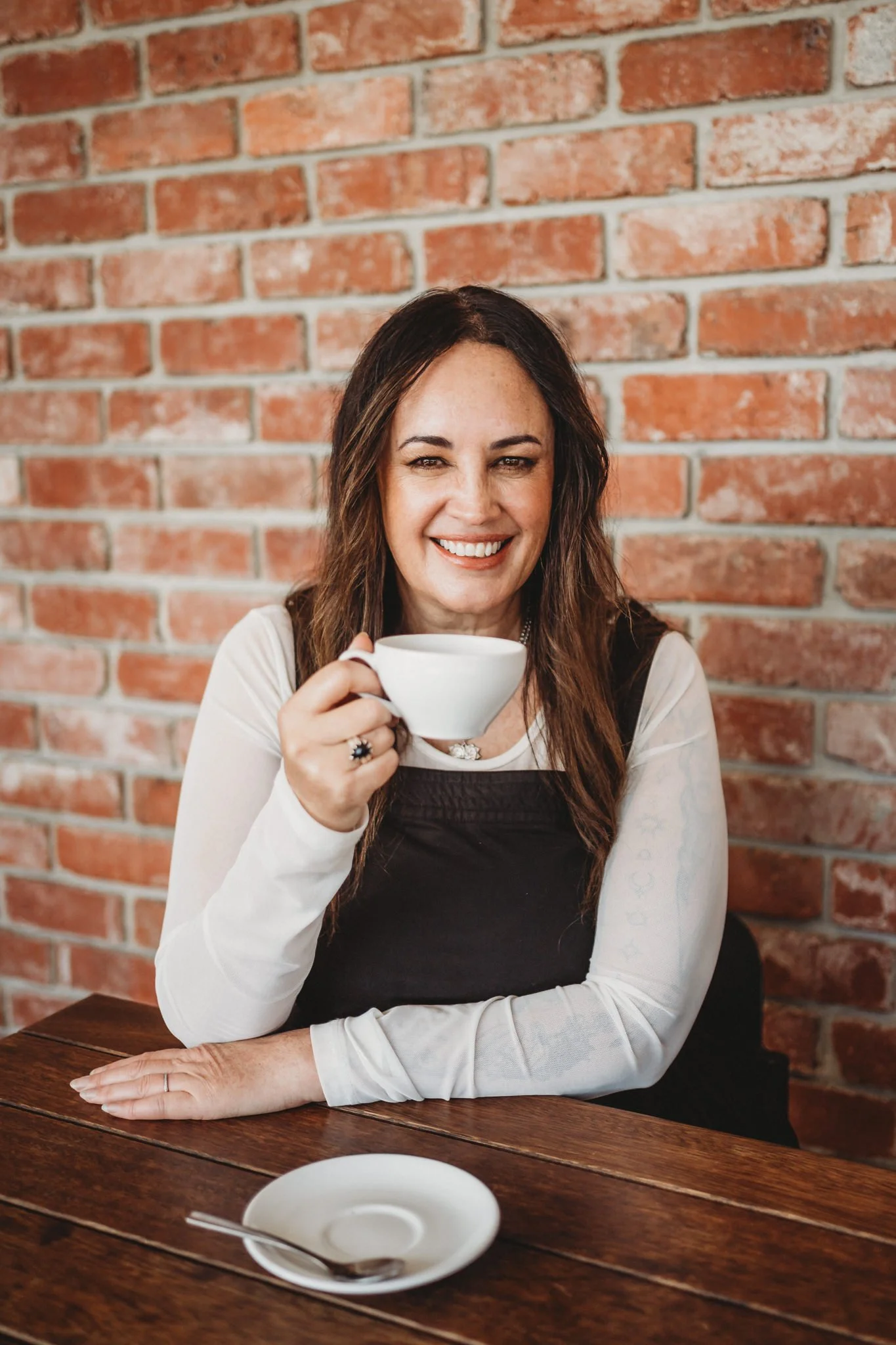 Casual headshot of Masterton business owner smiling over a cup of tea.